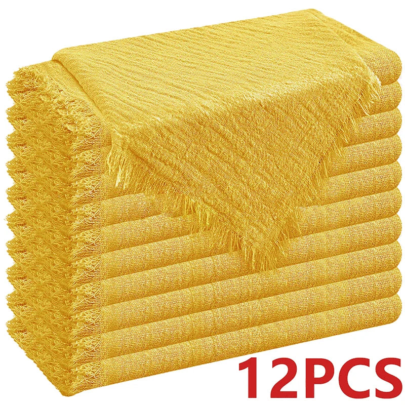 A stack of ten golden yellow raw-edge polyester cloth napkins.