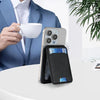 A black magnetic leather wallet case for an iPhone is shown next to a white cup and a blue suit jacket.