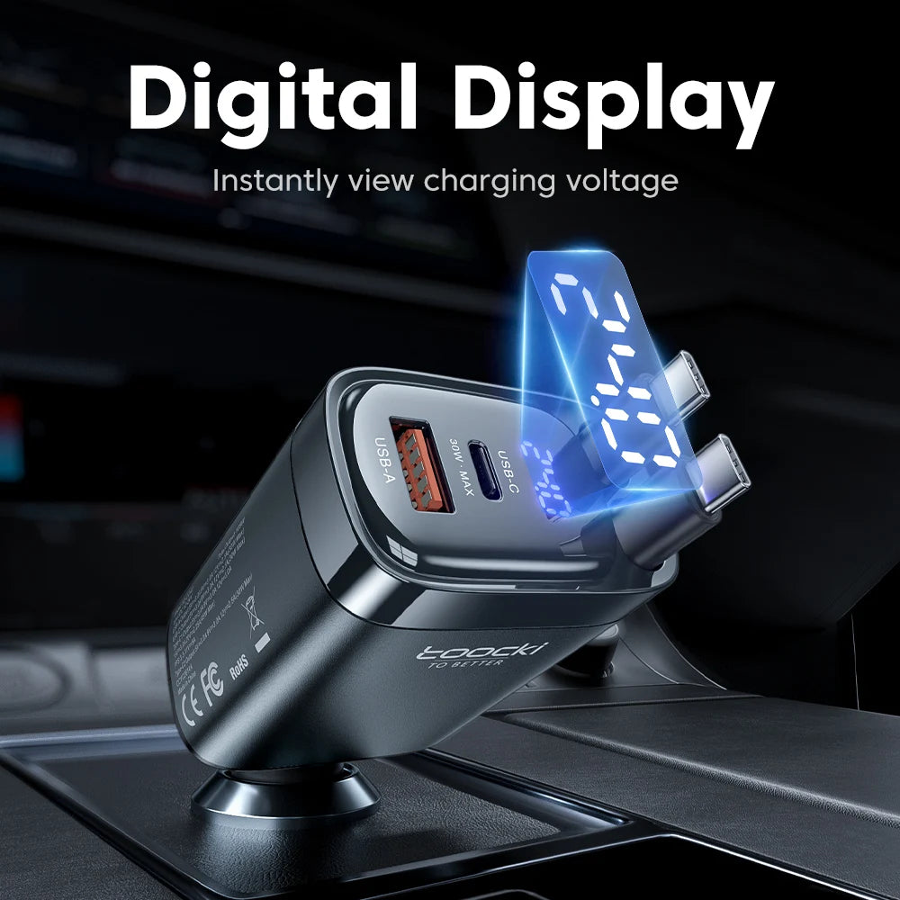 A close-up of a black car charger with a blue digital display showing charging voltage.