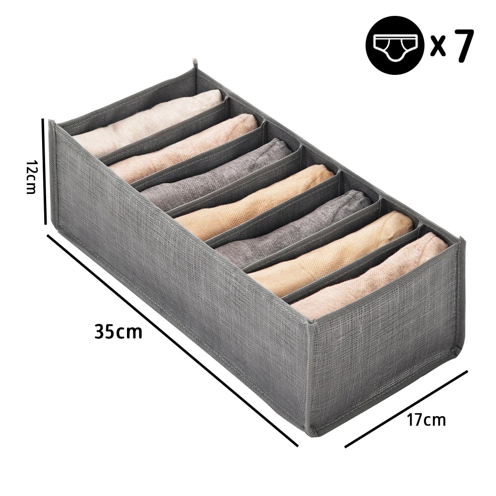 Gray fabric closet organizer with seven folded beige and gray fabric items inside