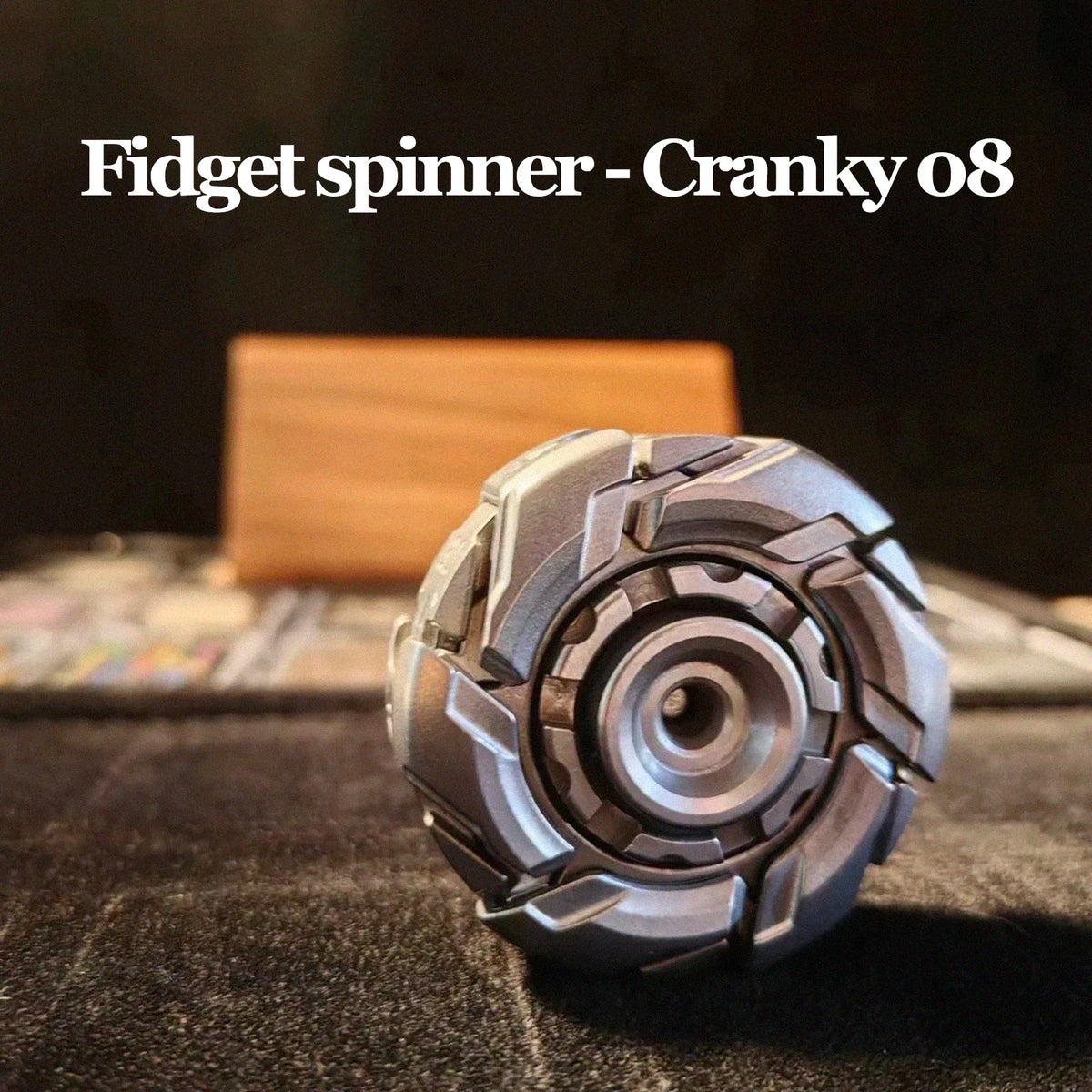 A close-up shot of a silver fidget spinner resting on a dark surface.