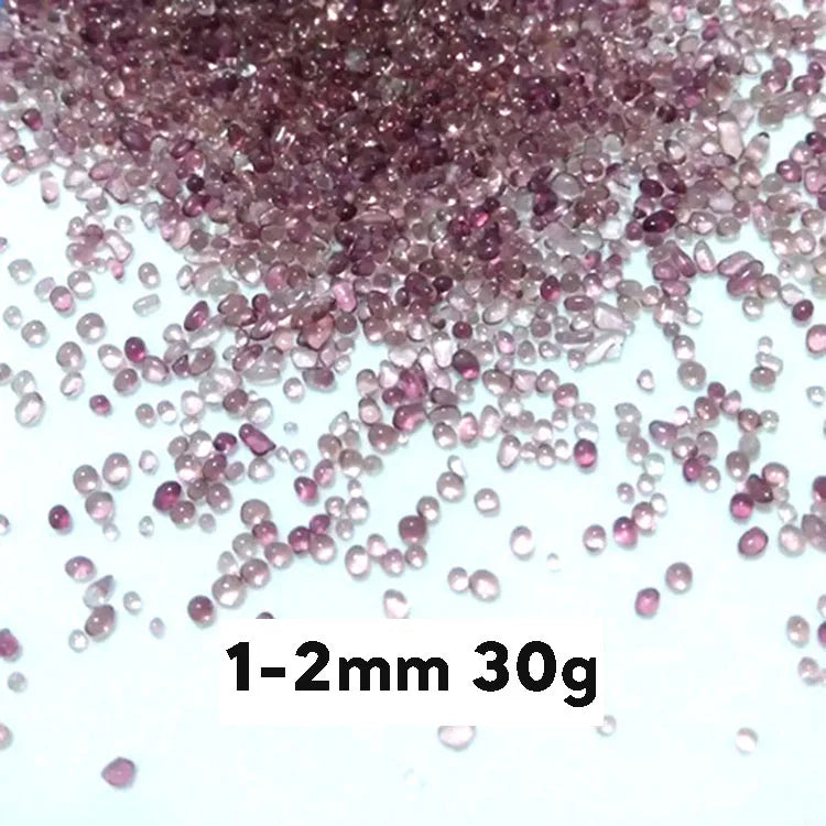 A pile of small, translucent pinkish-purple decorative stone pebbles measuring 1-2mm and weighing 30 grams.