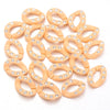 A set of twenty peach-colored acrylic jewelry connector clasps with crystal accents.