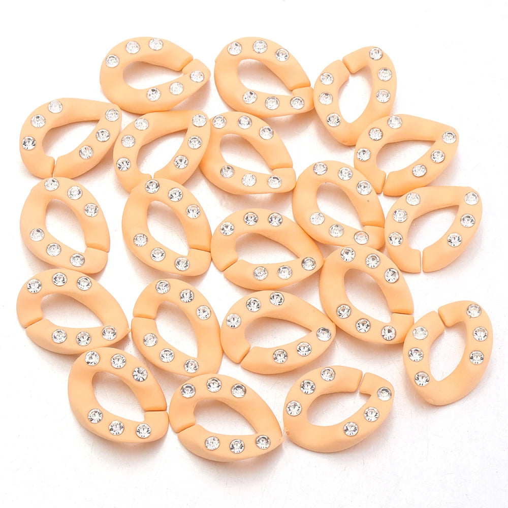A set of twenty peach-colored acrylic jewelry connector clasps with crystal accents.