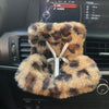 A fluffy, leopard-print faux fur decoration shaped like a doll seat car vent cover.