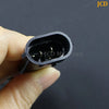 A hand holds an H8/H11 headlight adapter wiring harness with a 15cm cable.