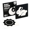A box of Baby Vision Trigger Cards for 0-3 months, featuring a black and white visual card with a crescent moon design.