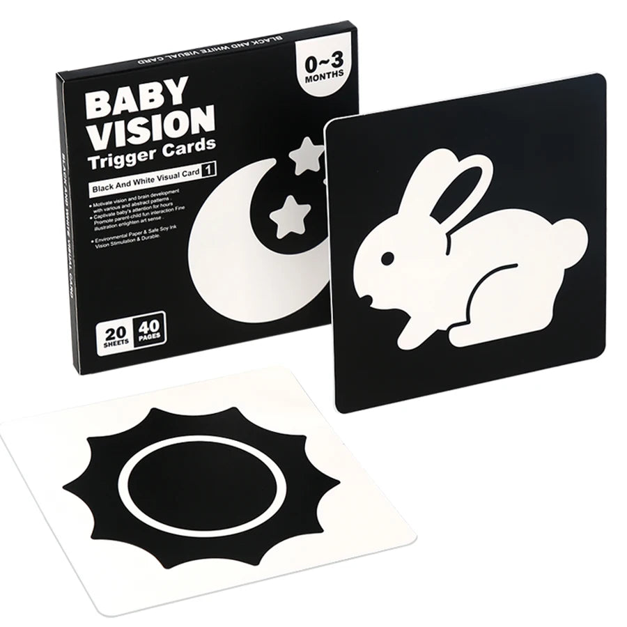 A box of Baby Vision Trigger Cards for 0-3 months, featuring a black and white visual card with a crescent moon design.