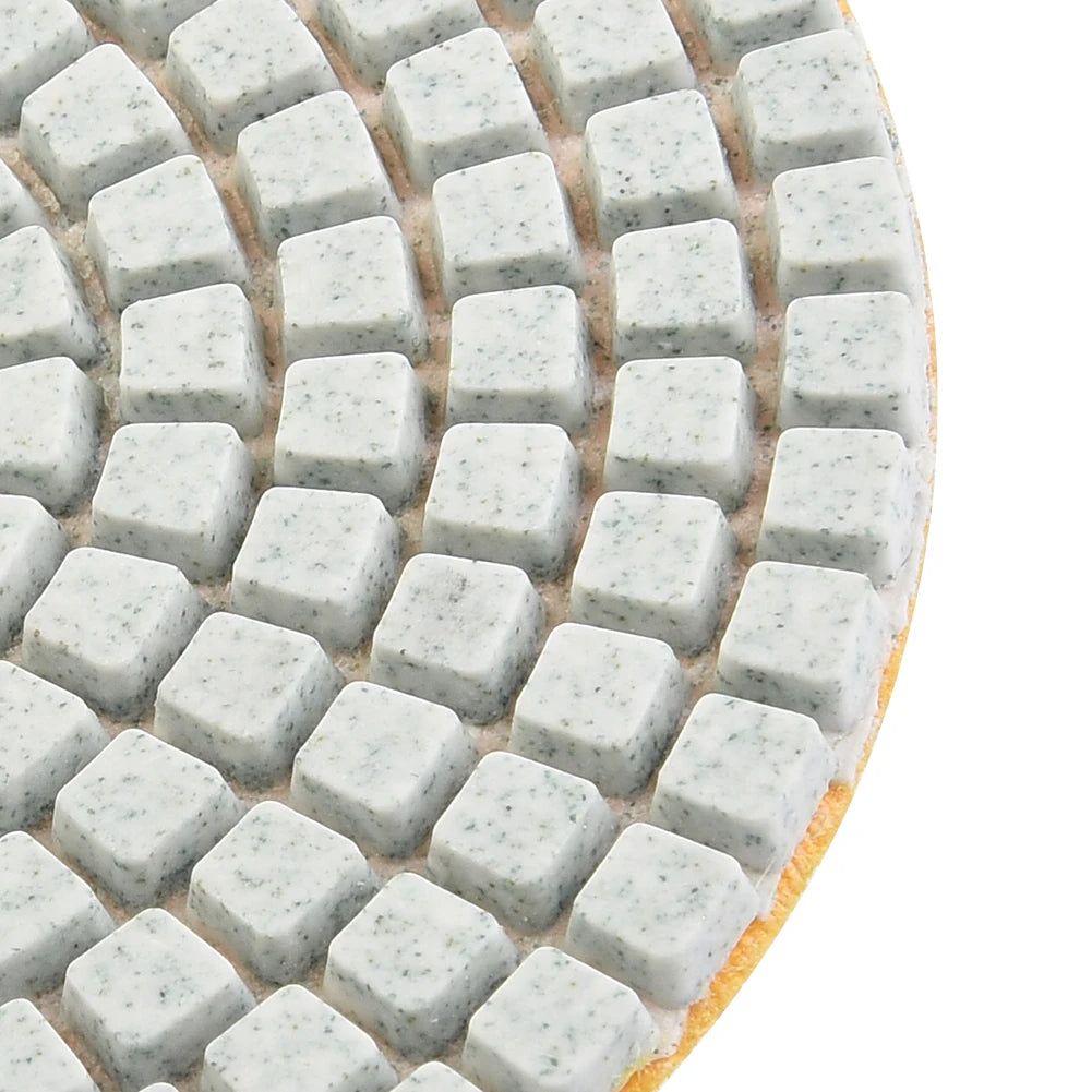 A close-up view of a set of diamond polishing pads for stone and concrete, showing various grits.