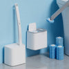 A wall-mounted toilet brush set with a white handle and disposable blue heads is shown next to a toilet.