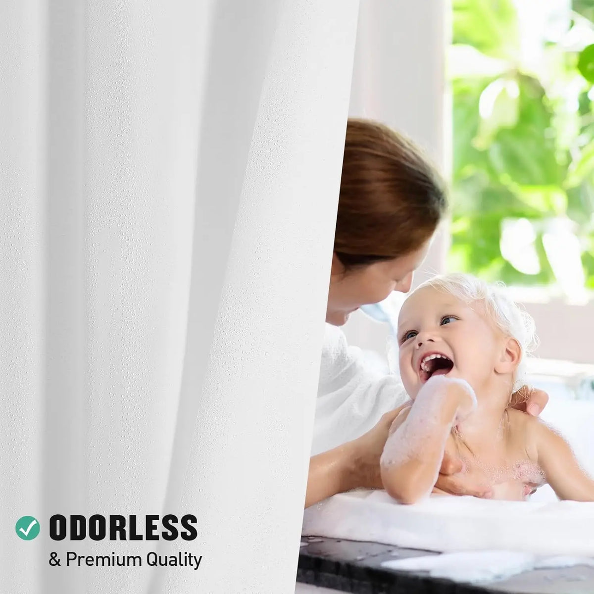 A young child is laughing while being washed under a white shower curtain liner.