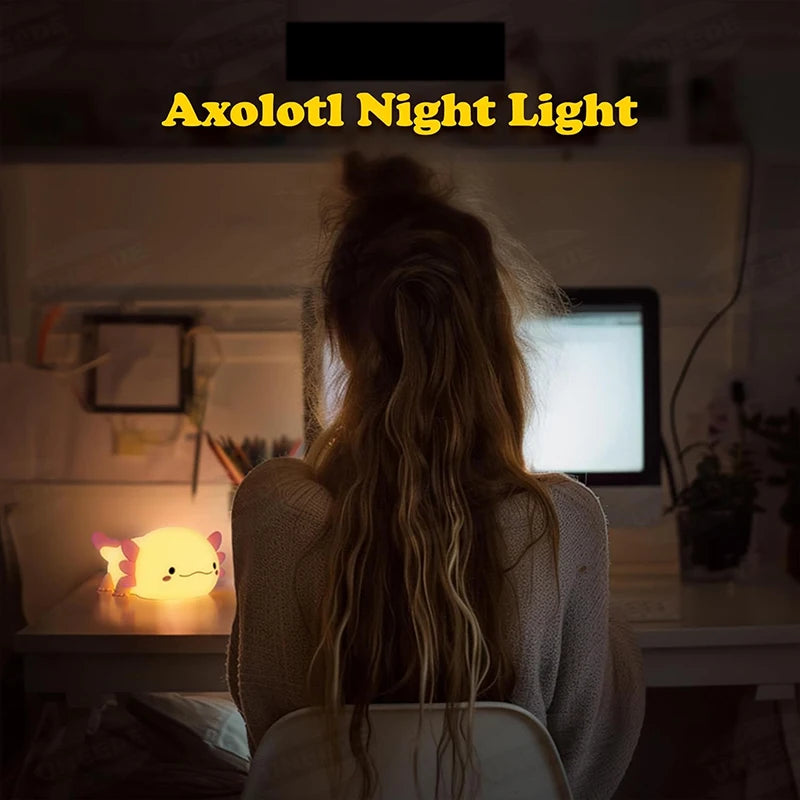 A person's back is visible, looking at a cute Axolotl night light glowing on a table.