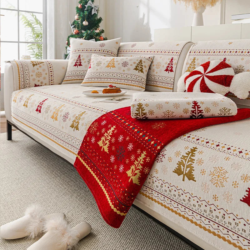 Christmas tree patterned sofa covers featuring red and gold accents on a light-colored fabric.