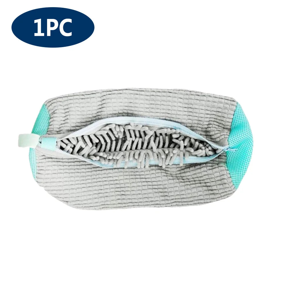 A grey reusable mesh laundry bag for shoes with light blue trim.