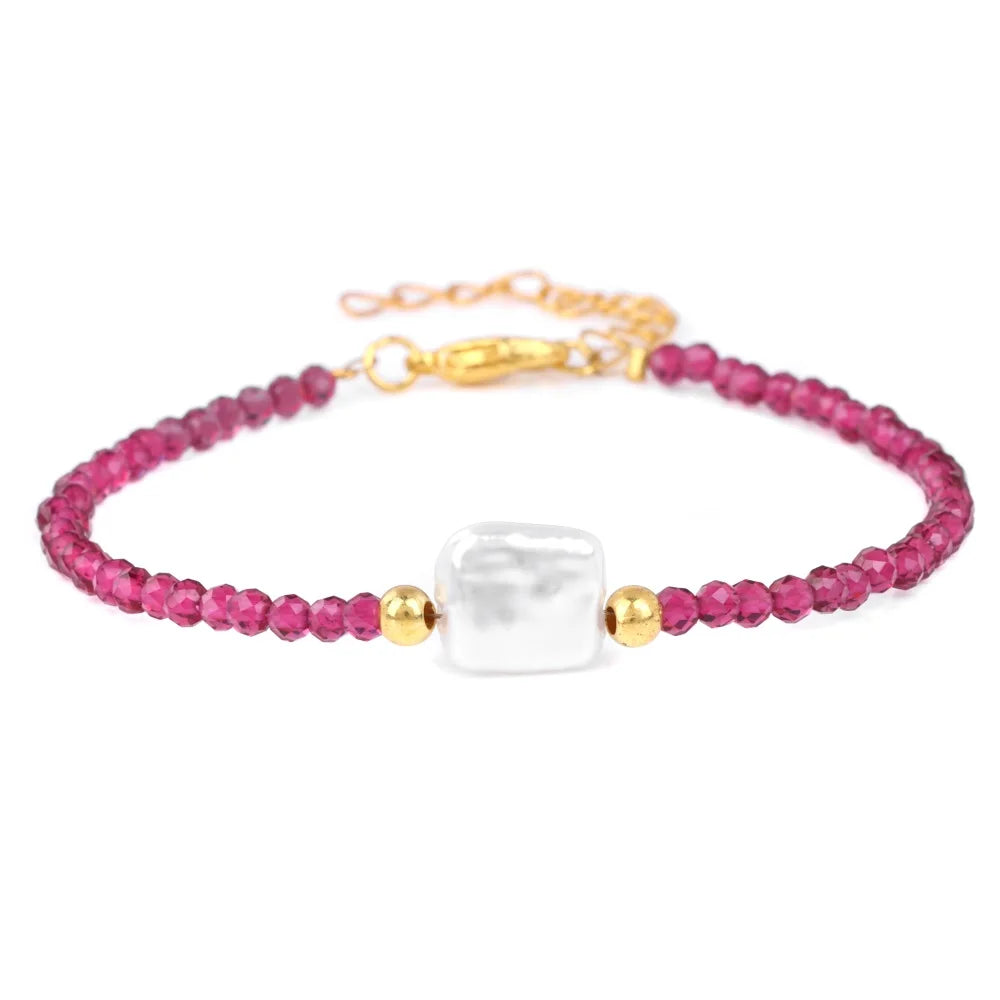 A pink natural stone bead bracelet with a white stone centerpiece and gold-toned adjustable lace-up closure.