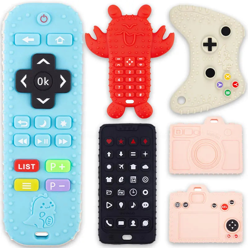 A collection of silicone baby teether toys including a remote control shape, a game controller, and two camera-shaped items.