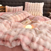 A pink and cream ultra-soft plush bedding set featuring faux fur pillows and a fluffy blanket.