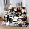 A printed flannel throw blanket featuring multiple portraits of Michael Jackson.