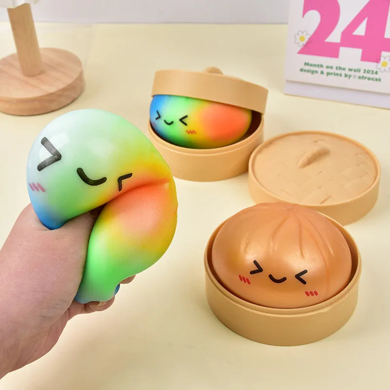 A hand holds a translucent, rainbow-colored squishy toy in its packaging box.