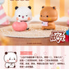 A set of cute animal figurines, including a white panda and a brown bear, displayed on a woven mat.
