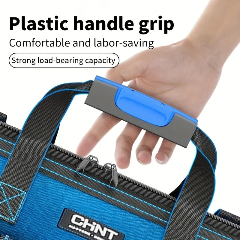 A hand grips a plastic handle grip on a blue tool bag featuring a black zipper and branding.