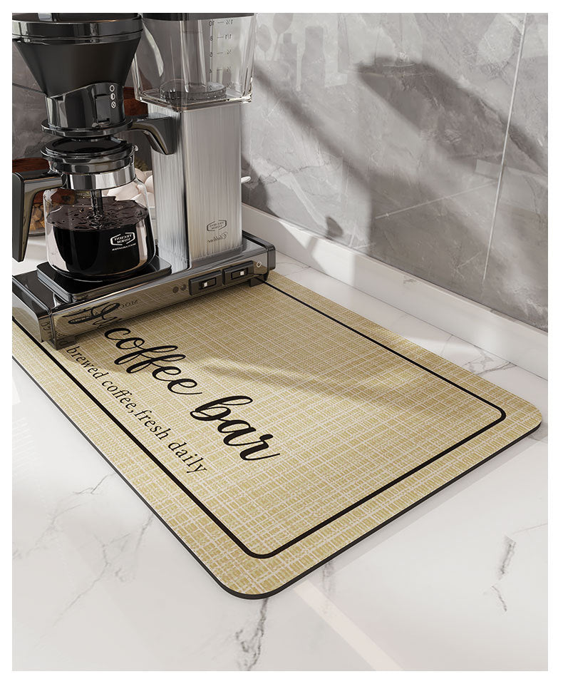 A black coffee grinder and water filter are placed on a yellow and black coffee bar mat on a marble countertop.