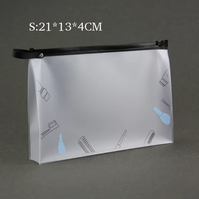 A transparent toiletry bag with a black zipper and hanging hook, featuring various grooming tools illustrated on the surface.