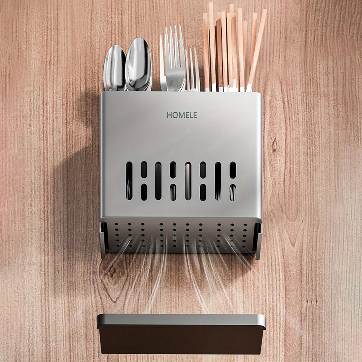 A silver cutlery organizer with a drain tray and a separate dark tray is shown against a wooden background.