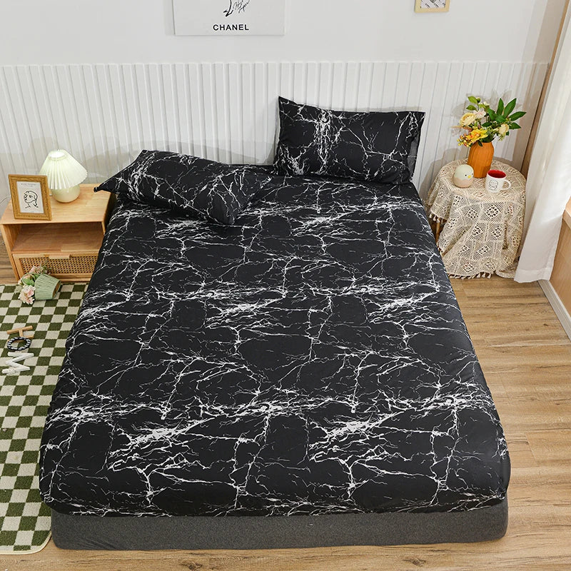 Black and white marbled print fitted bed sheet displayed on a bed with pillows and surrounding decor.