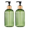 A pair of refillable soap dispensers with green glass bottles and wooden caps.