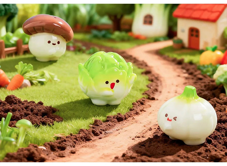 Hand-painted resin vegetable figurines, including mushrooms, peas, and pumpkins, displayed in a garden setting.