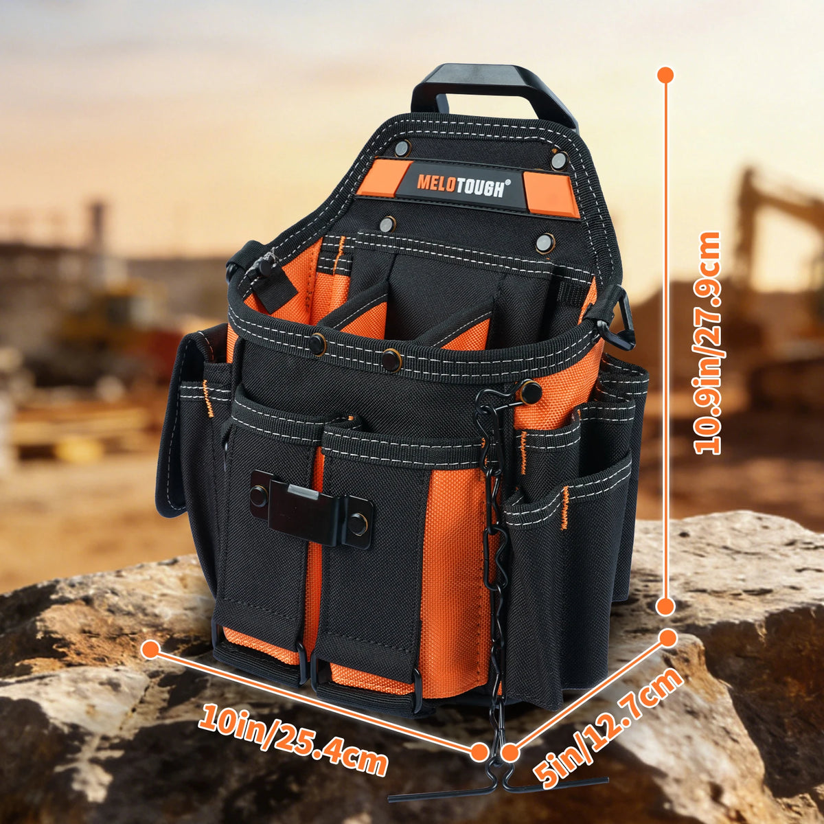 Black and orange heavy-duty tool pouch with an adjustable strap and belt clip resting on a rock.