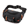 Black tactical chest bag with an orange strap and buckle, shown from above.