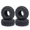 A pair of black rubber mud terrain tires with knobby treads mounted on black rims.