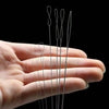 A hand holds a set of seven ultra-fine beading needles for jewelry making