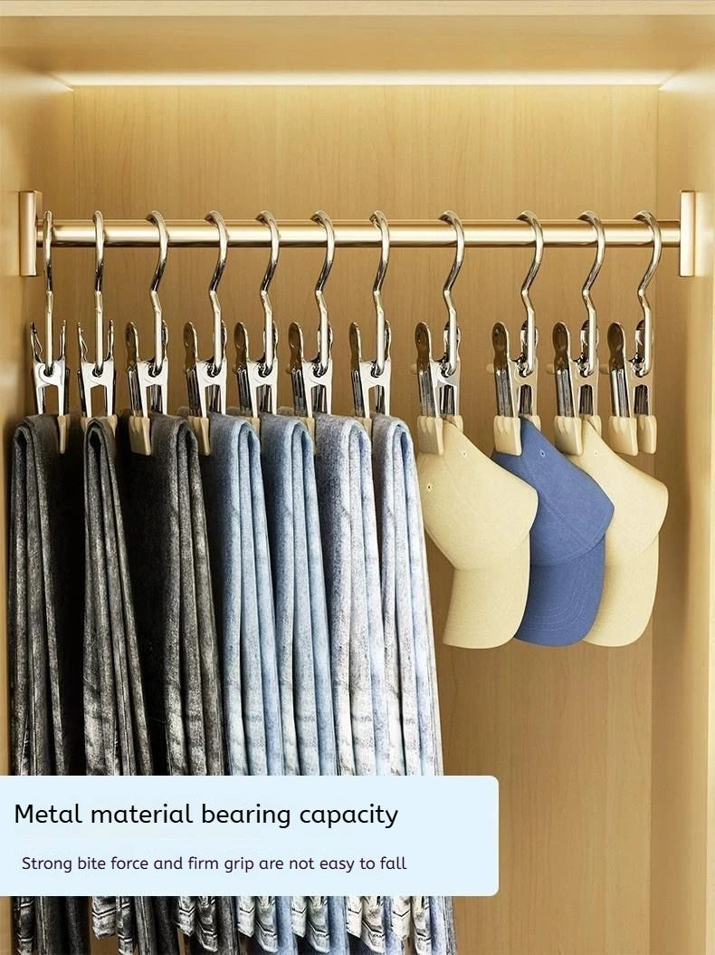 A display of metal clothespins with hooks hanging on a rod, featuring various shades of gray and blue fabric.