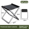 A silver metal folding stool with a black seat, shown in various dimensions and material details.