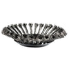 A close-up view of a black carbon steel wire trimmer head with multiple fine wires.