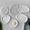 White silicone tray molds shaped like hearts and circles for crafting resin, gypsum, and clay