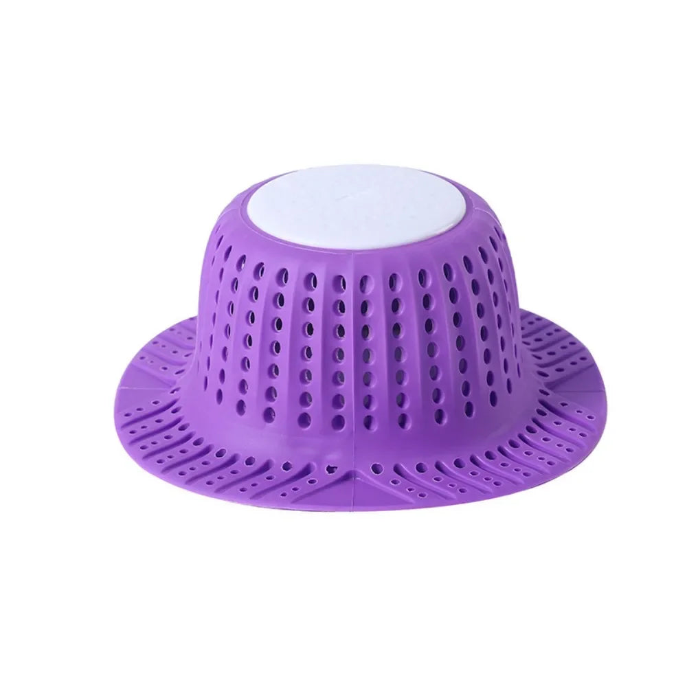 Purple collapsible silicone drain hair catcher with a white top for bathtubs and sinks