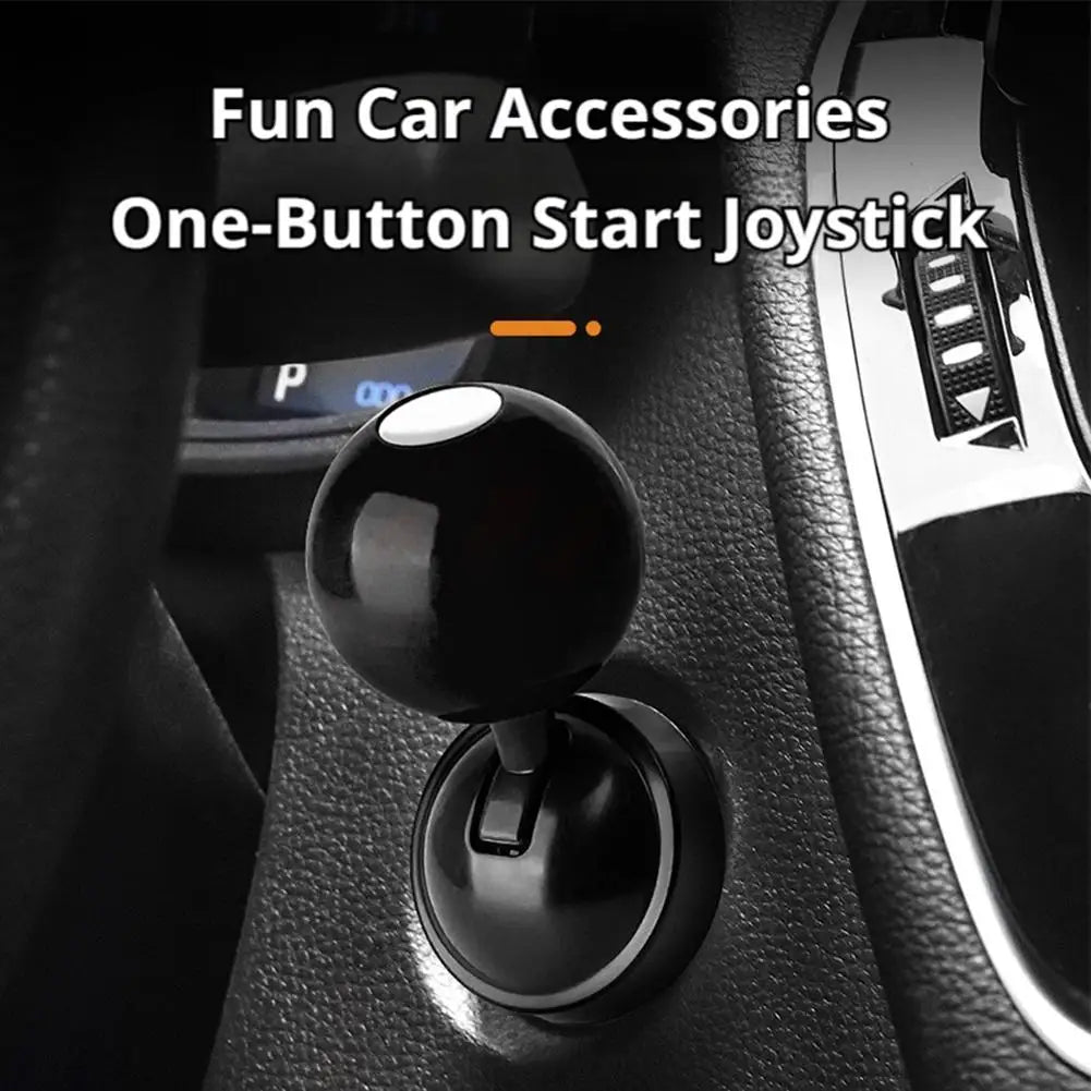 A black push-to-start joystick accessory with a billiard ball design installed in a car interior.
