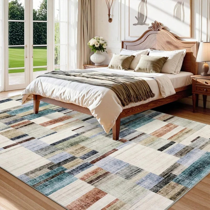 A modern western style area rug featuring a patchwork design of brown, gray, blue, and beige tones.