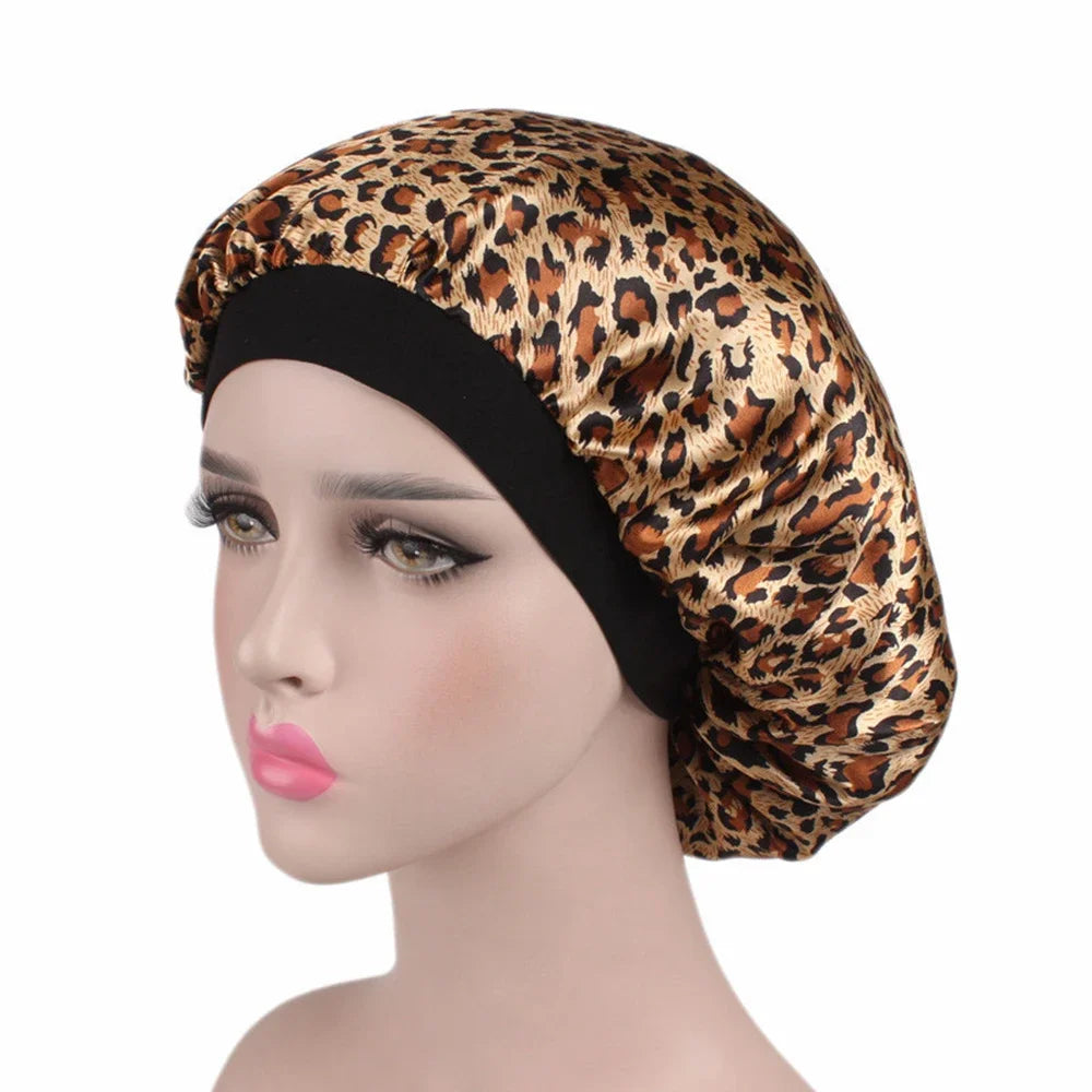 A woman wearing a gold and brown leopard print satin hair bonnet on a mannequin head.