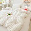 A white lightweight seersucker duvet cover set displayed on a bed with a decorative pillow and a small stuffed animal.