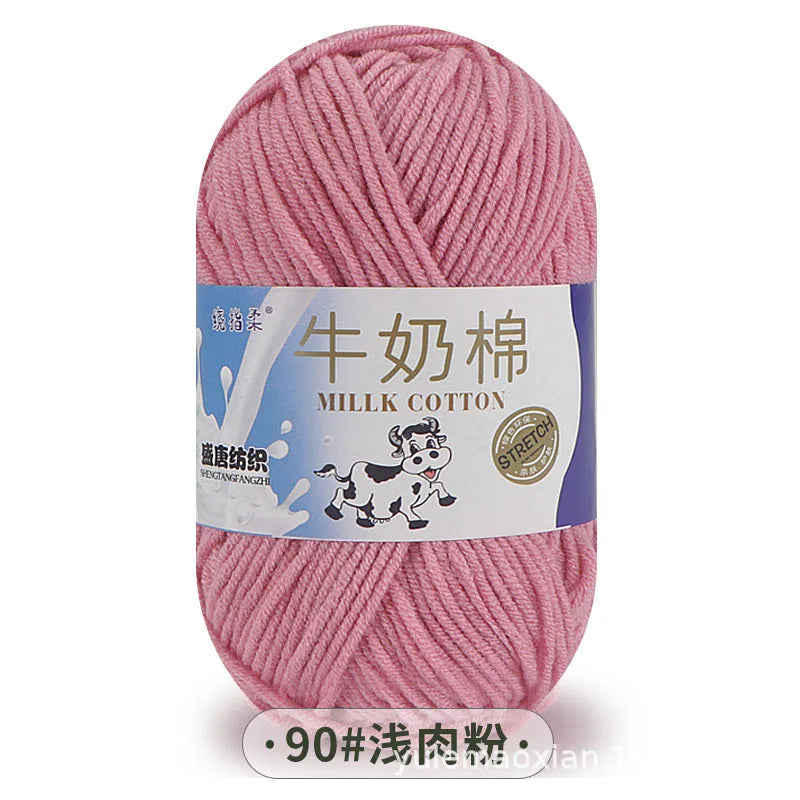 A ball of pink milk cotton blend yarn with a label in Chinese and English.