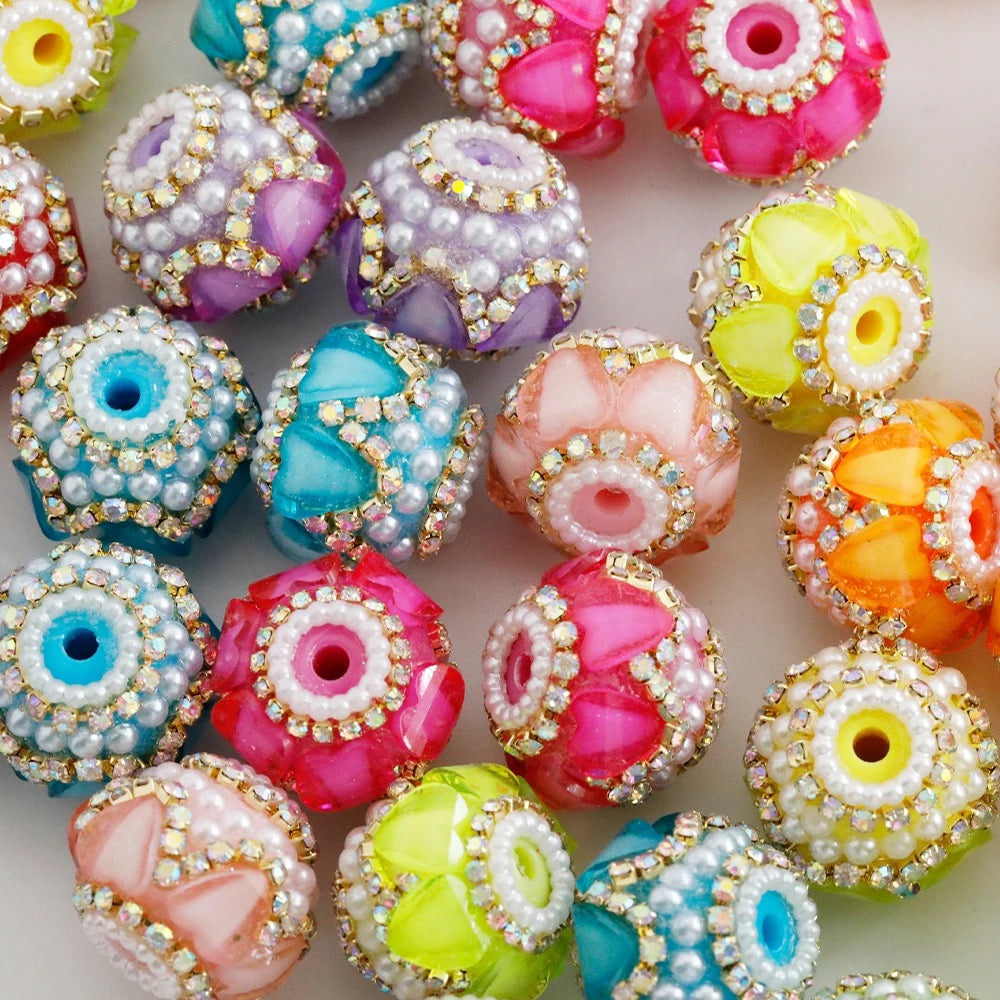 A collection of colorful rhinestone round beads in various shades including pink, purple, yellow, and blue.