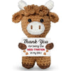 A brown crochet animal doll with white accents, featuring a card that reads Thank You for being the moo-tivation in my life.