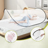 A woman is sleeping on a bed covered by an instant pop-up mosquito net for protection.