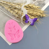 Pink silicone butterfly molds for soap, chocolate, and resin crafts displayed next to dried natural grasses.