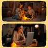 A person is using a laptop next to a squishy fox night light on a wooden table.